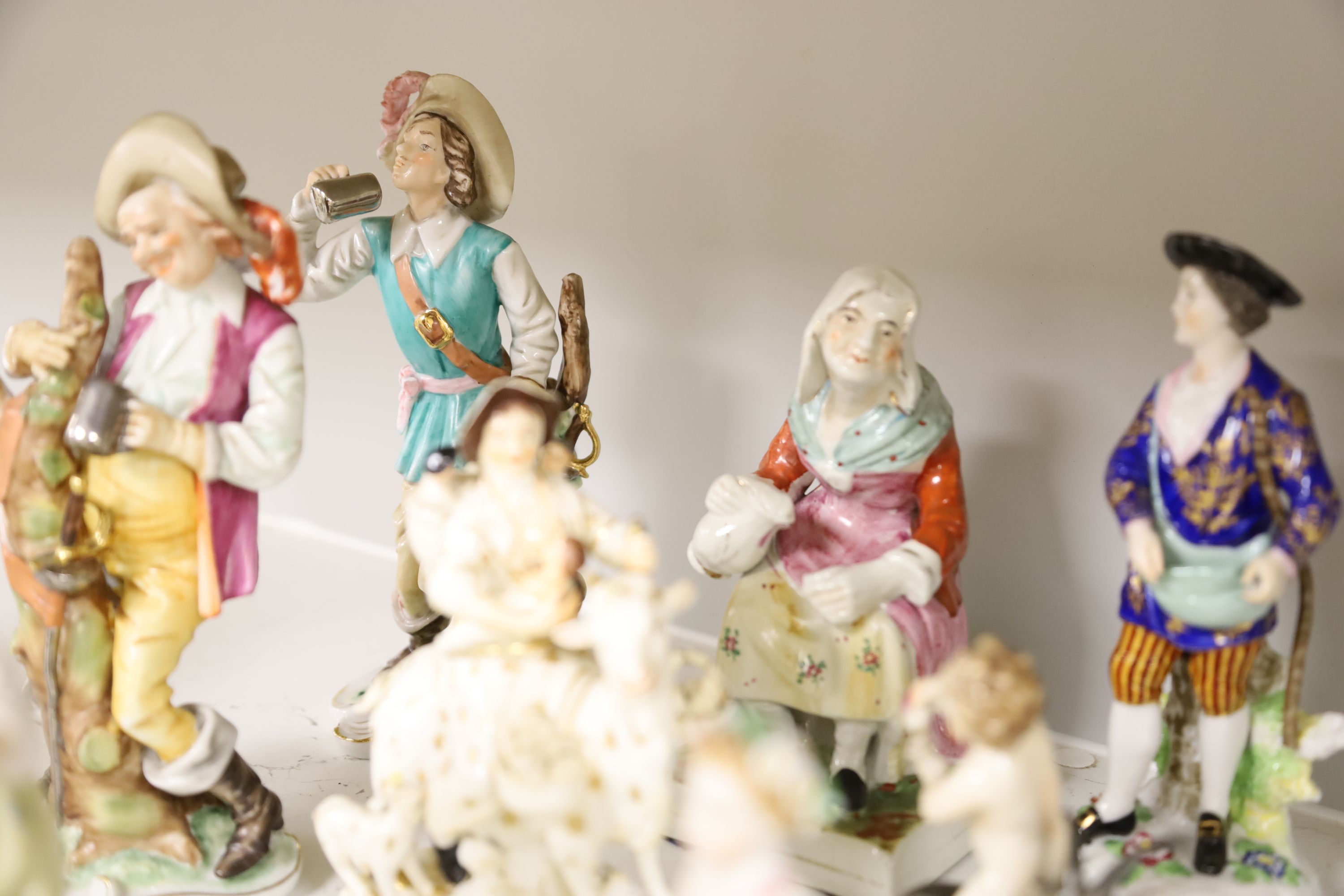 A Derby tailors wife group and twelve Continental or Staffs porcelain figures, tallest 20cm